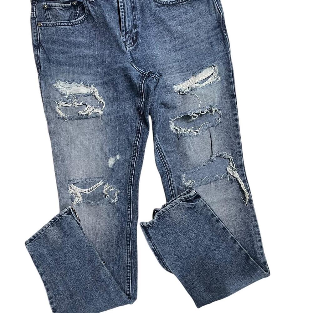 Distressed blue denim jeans